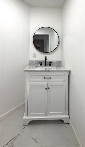 a room with a sink and mirror