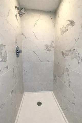 a white toilet sitting next to a bath tub and shower