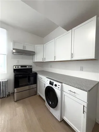 a utility room with sink dryer and washer