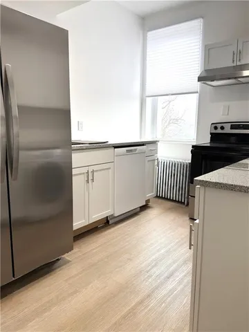 a view of a kitchen with electric appliances