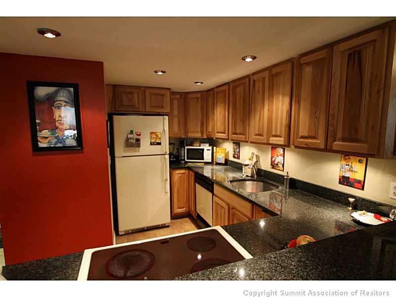 800 Copper Road, Unit 178 Copper Mountain, CO 80443 - Photo 4 of 19 a kitchen with stainless steel appliances granite countertop a sink refrigerator and cabinets