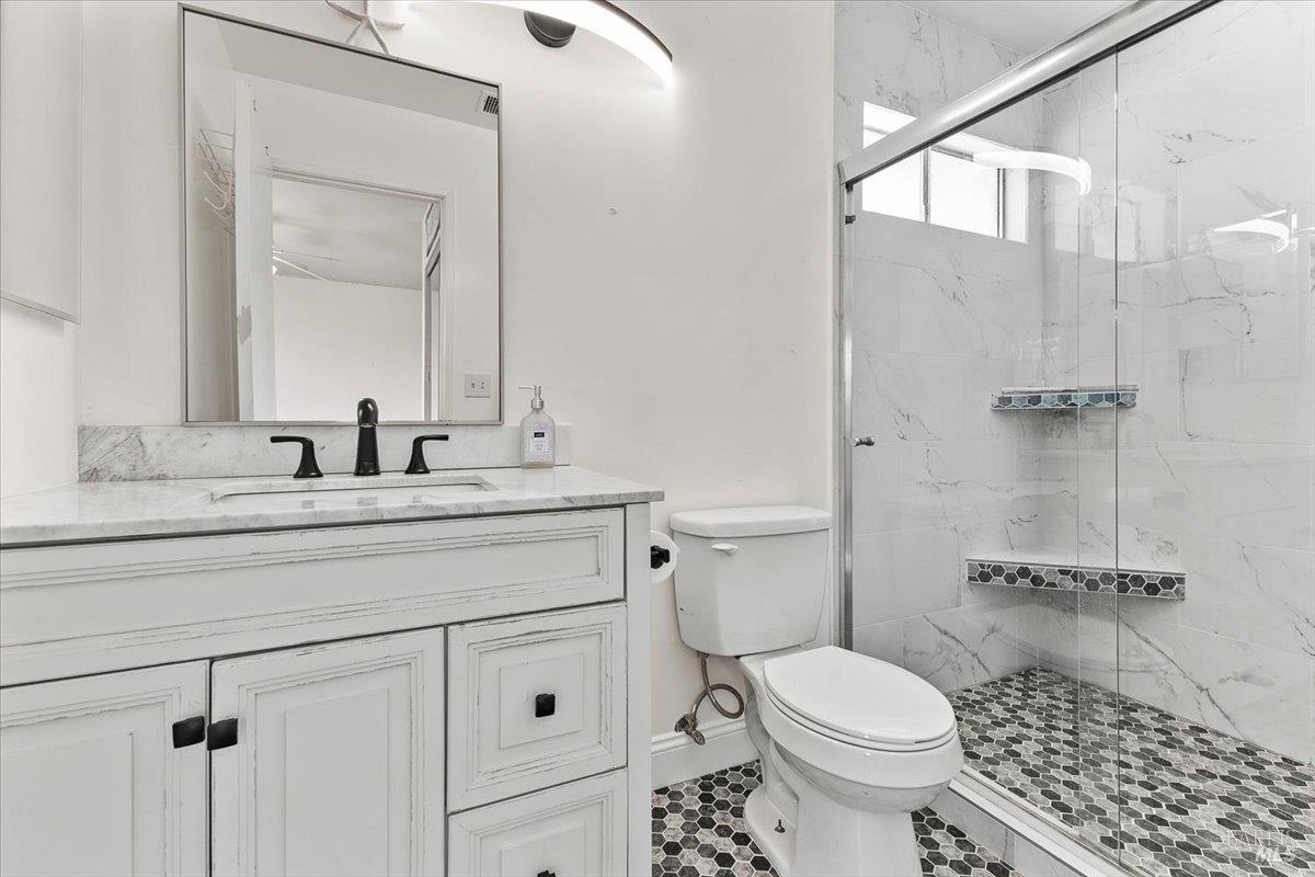 4457 Graywhaler Lane Rohnert Park, CA 94928 - Photo 27 of 51 a bathroom with a granite countertop toilet sink and a mirror