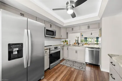 a kitchen with stainless steel appliances a refrigerator sink and microwave