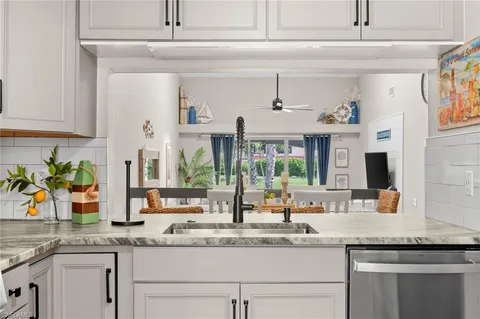 a kitchen with granite countertop a sink and a window