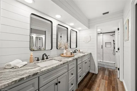 a spacious bathroom with a granite countertop sink mirror and double