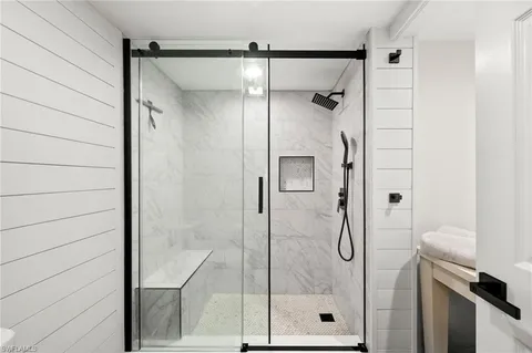 a bathroom with a glass shower door