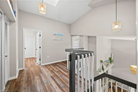 a view of hallway with wooden floor