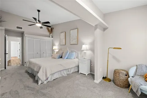 a bedroom with bed and a chandelier