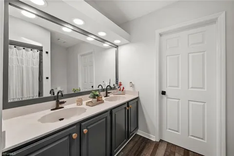a bathroom with a double vanity sink and a mirror