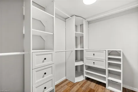 a view of walk in closet with empty racks