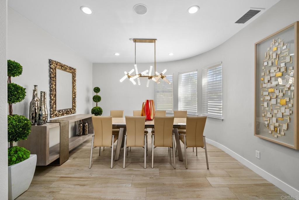 13251 Devon Drive Jamul, CA 91935 - Photo 24 of 73 a dining room with furniture a chandelier and wooden floor