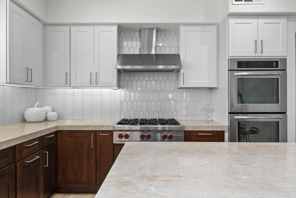 13251 Devon Drive Jamul, CA 91935 - Photo 28 of 73 a kitchen with stainless steel appliances a stove sink and cabinets