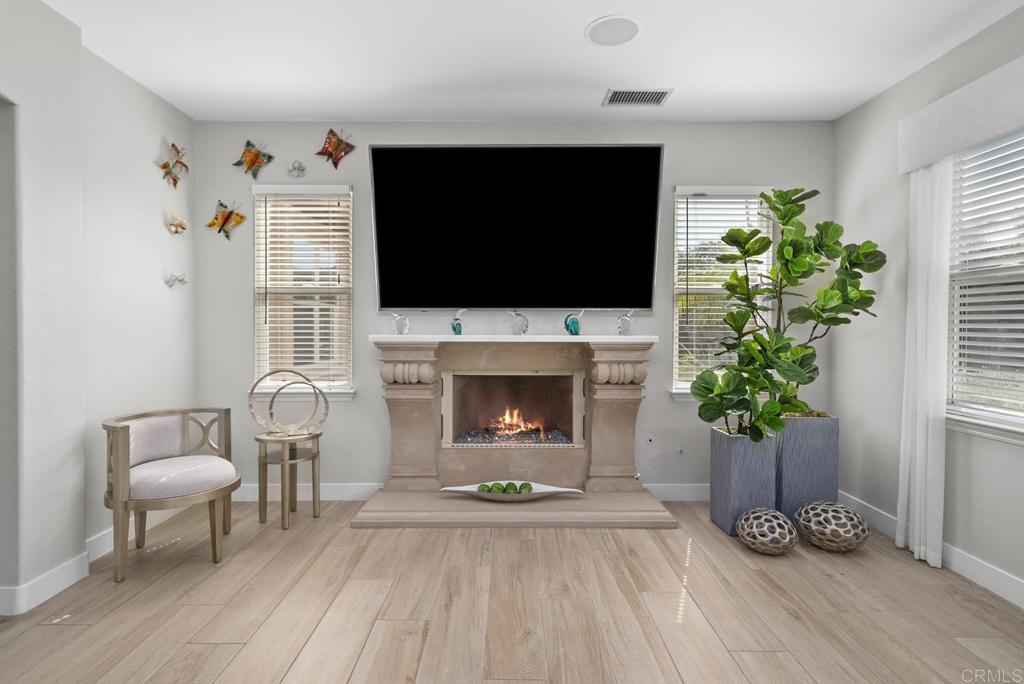 13251 Devon Drive Jamul, CA 91935 - Photo 39 of 73 a living room with furniture a flat screen tv and a fireplace