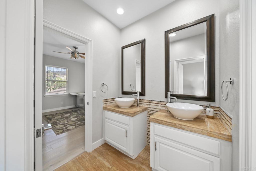 13251 Devon Drive Jamul, CA 91935 - Photo 55 of 73 a bathroom with a granite countertop sink and a mirror