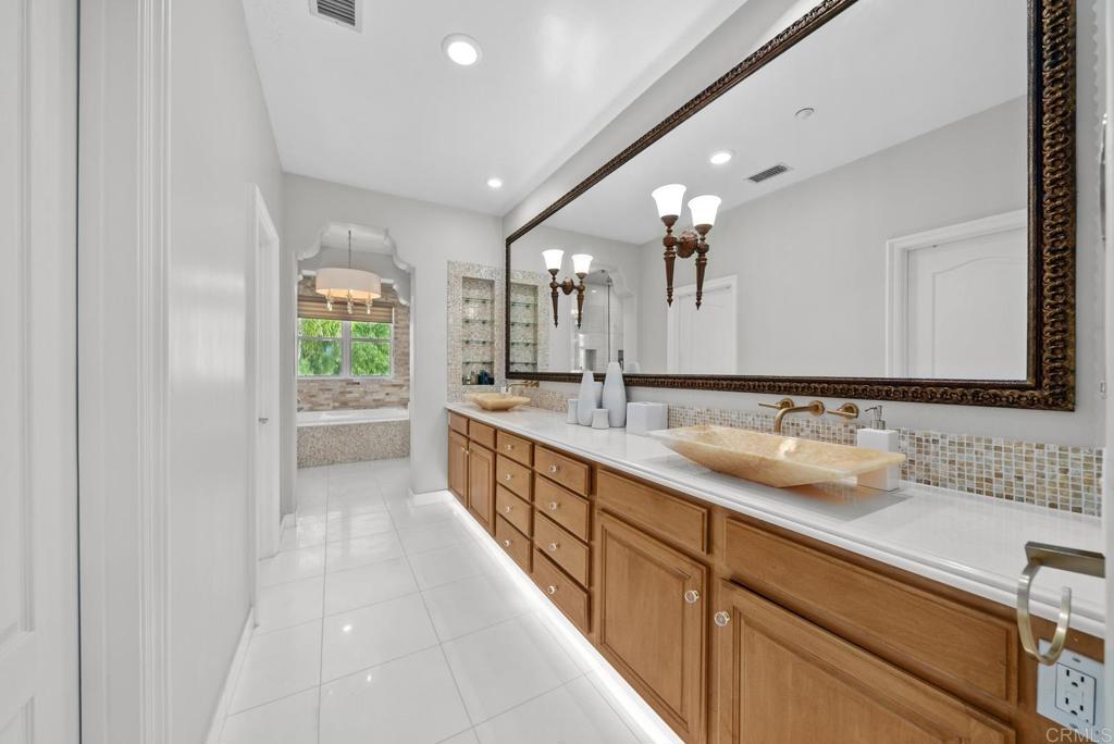 13251 Devon Drive Jamul, CA 91935 - Photo 66 of 73 a large bathroom with a double vanity sink and a large mirror