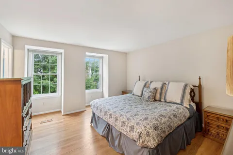 a large bed sitting in a bedroom next to a window