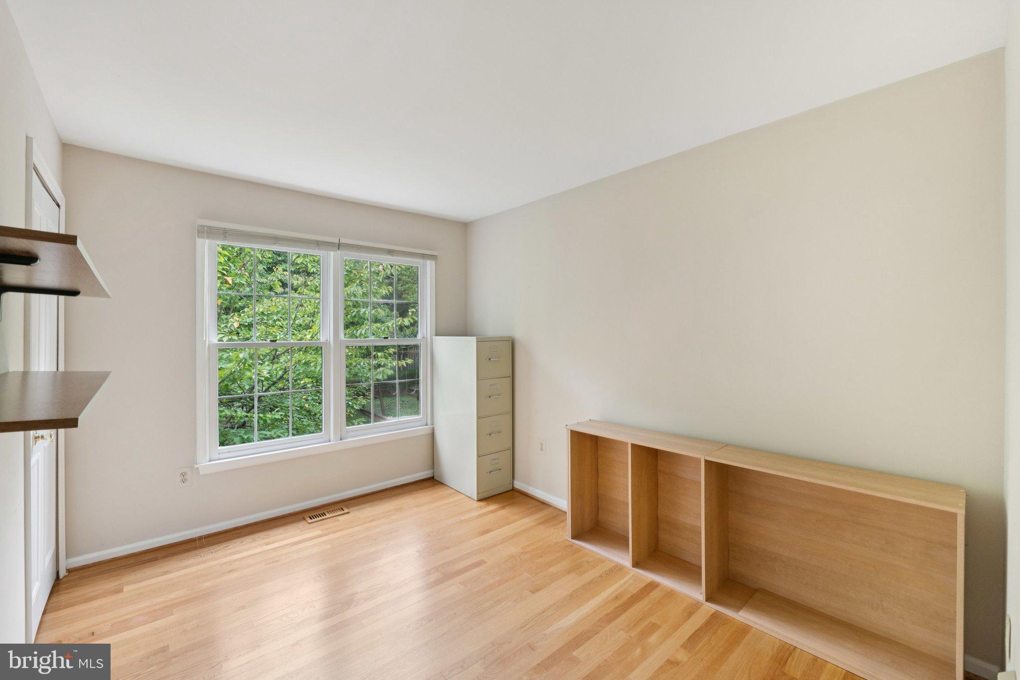 7904 Jensen Place Bethesda, MD 20817 - Photo 16 of 22 a view of an empty room with wooden floor and a window