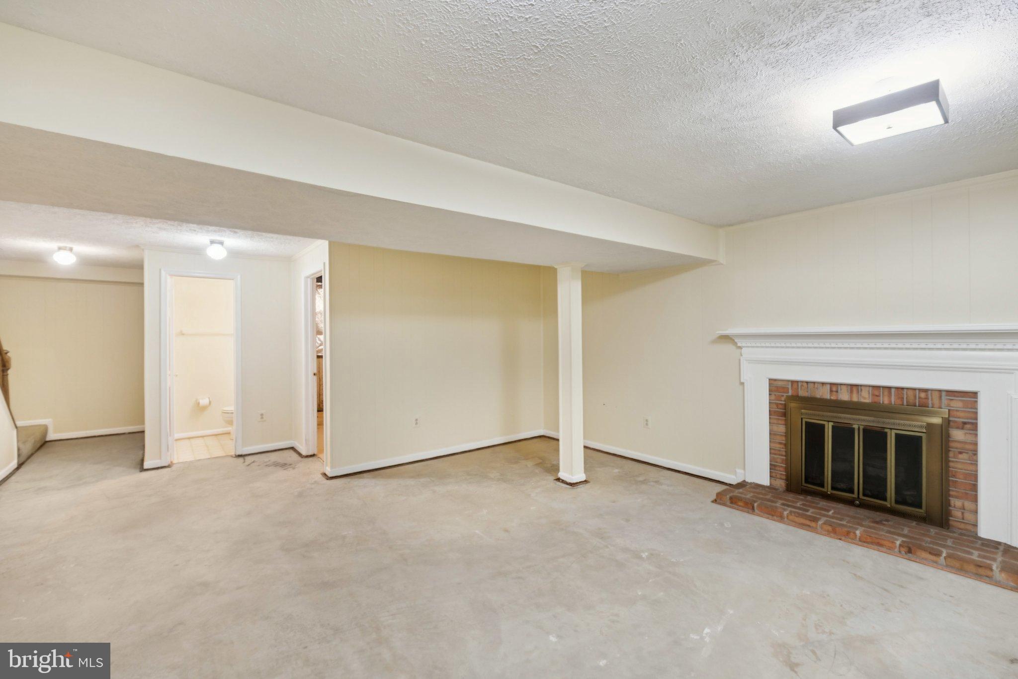 7904 Jensen Place Bethesda, MD 20817 - Photo 19 of 22 an empty room with a fireplace