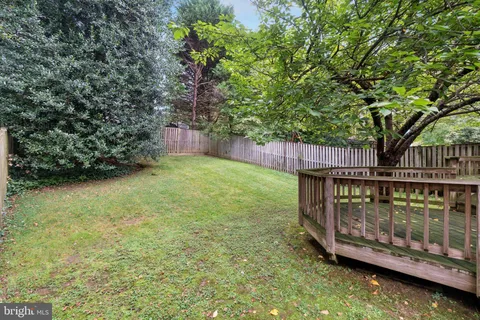 a view of a wooden deck with a small yard