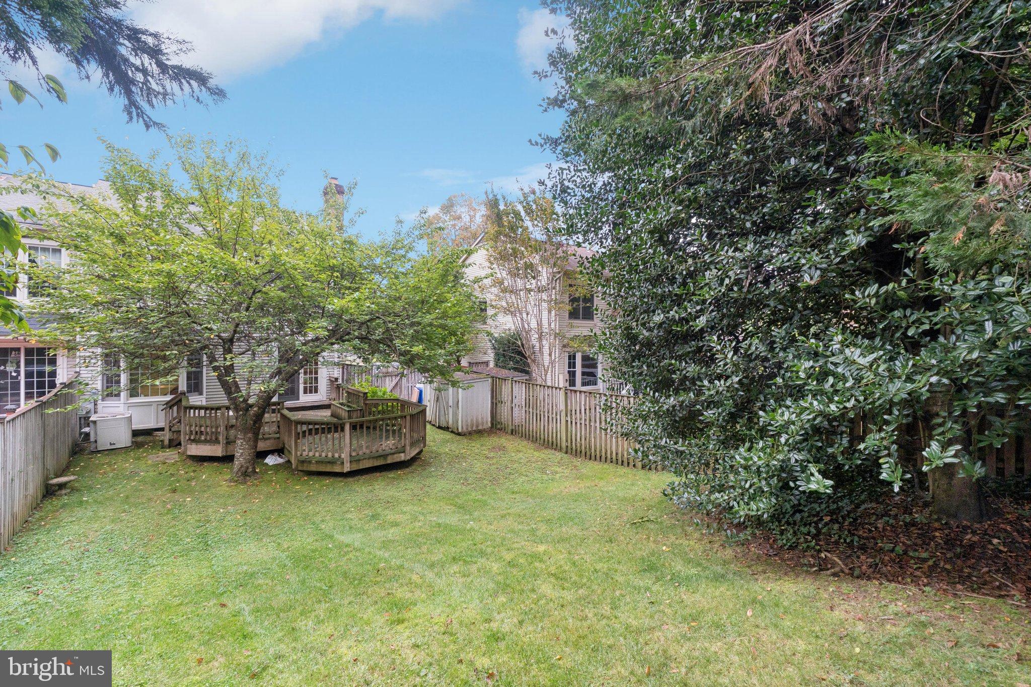 7904 Jensen Place Bethesda, MD 20817 - Photo 22 of 22 a backyard of a house with table and chairs