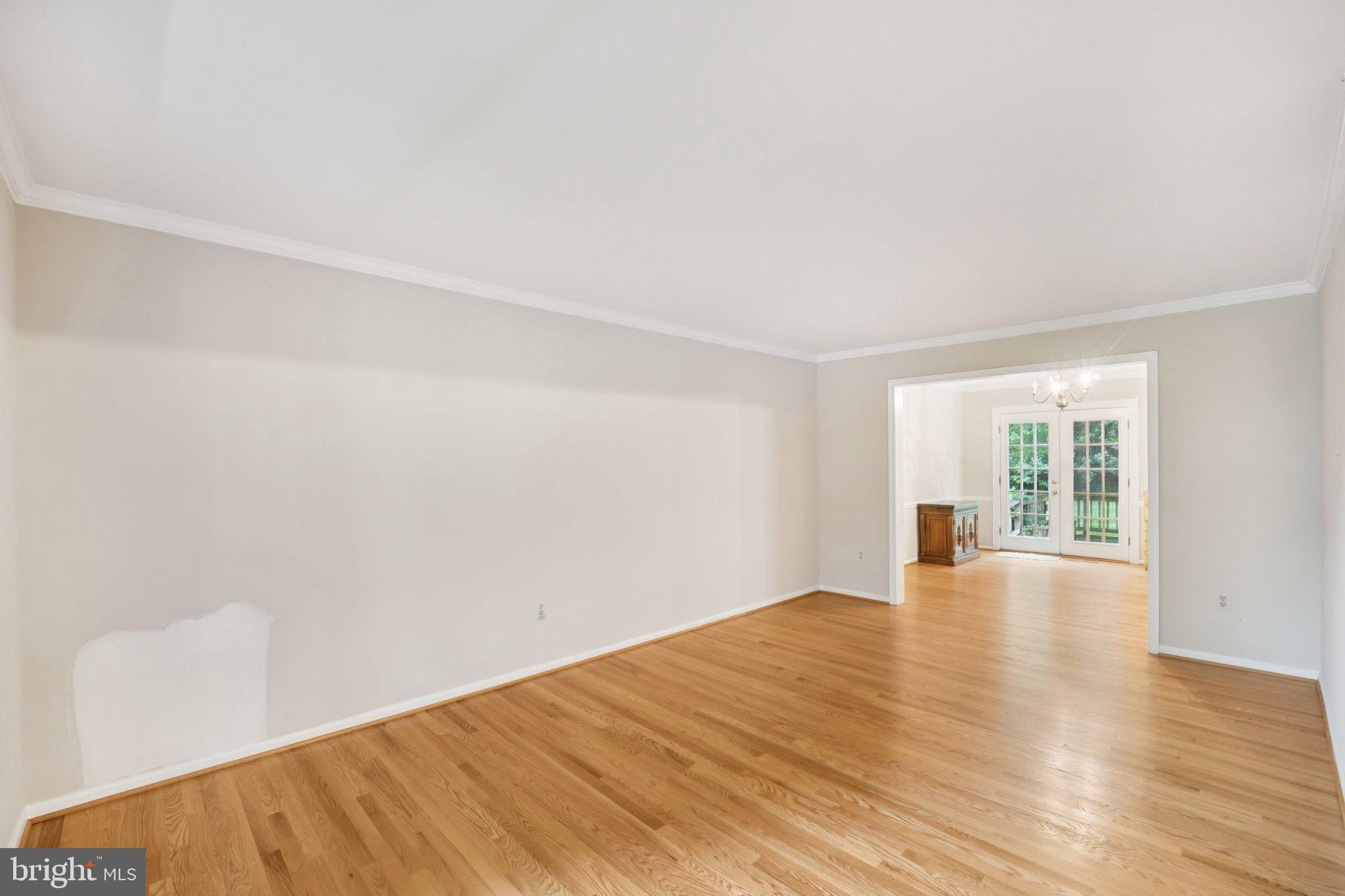 7904 Jensen Place Bethesda, MD 20817 - Photo 5 of 22 a view of an empty room with wooden floor and a window