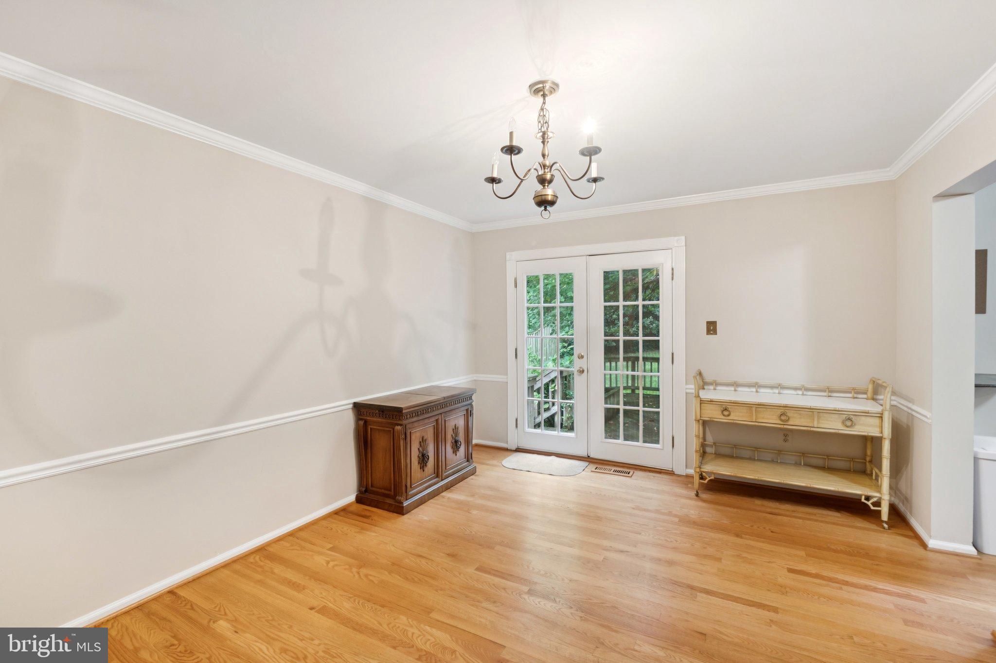 7904 Jensen Place Bethesda, MD 20817 - Photo 6 of 22 a view of a livingroom with wooden floor and a ceiling fan
