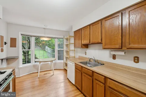a kitchen with a sink a counter top space and cabinets