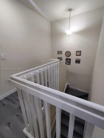 a view of a hallway with seating area