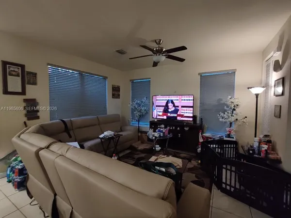 a living room with furniture and a flat screen tv