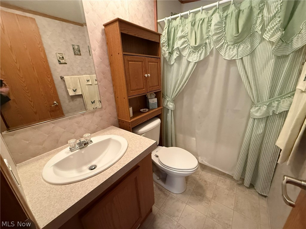 2933 Rabbit Drive Dennison, OH 44621 - Photo 24 of 28 Bathroom with wallpapered walls and vanity