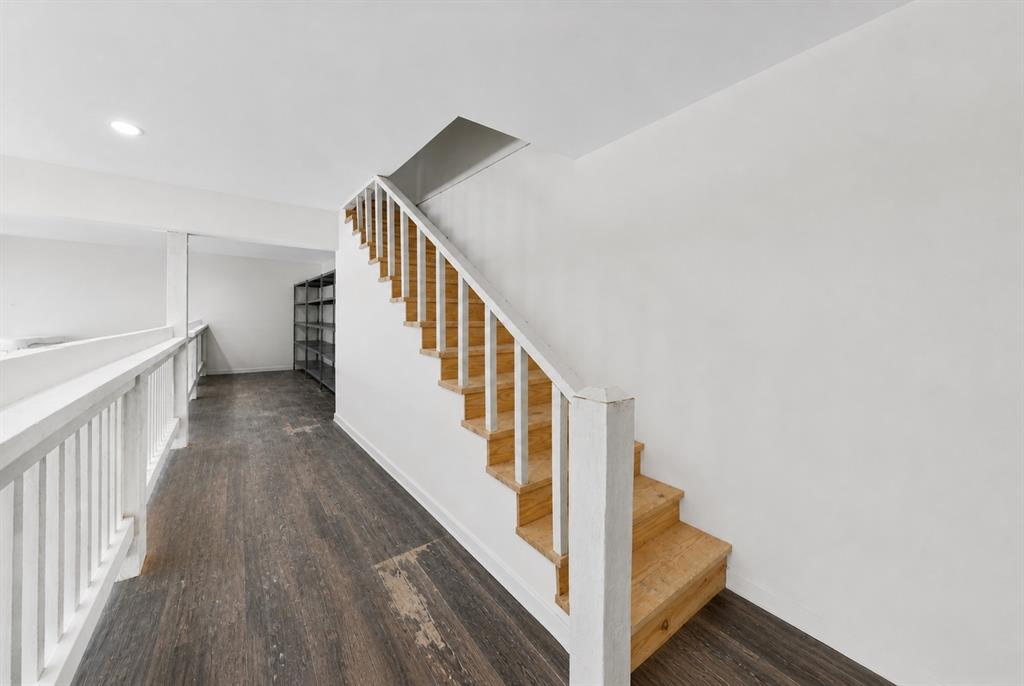 620 East 6th Street Springtown, TX 76082 - Photo 31 of 40 a view of staircase with wooden floor and white walls