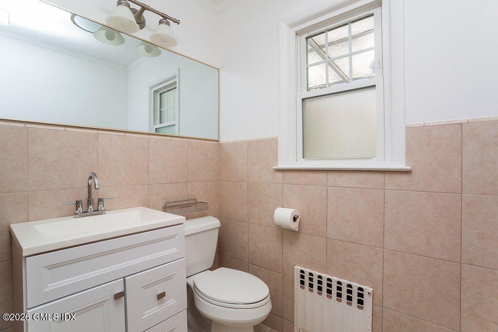 198 Valley Road Cos Cob, CT 06807 - Photo 14 of 31 a bathroom with a toilet a sink and mirror