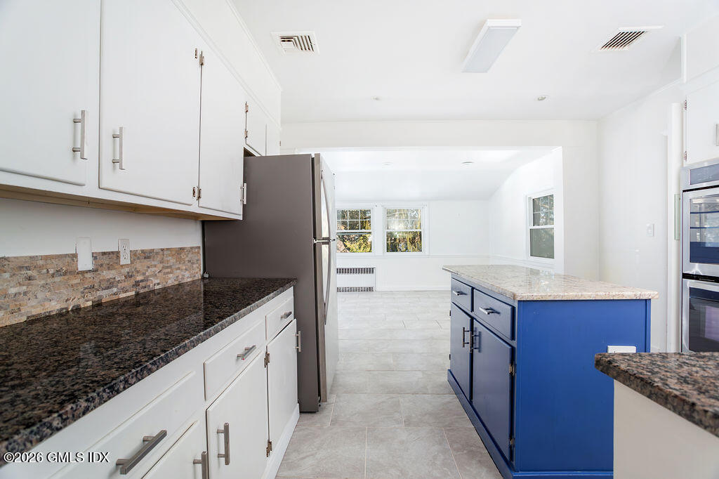 198 Valley Road Cos Cob, CT 06807 - Photo 8 of 31 a kitchen with granite countertop a sink and cabinets