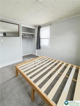 a bedroom with a bed and window