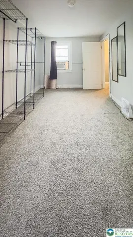 a view of an empty room with closet area