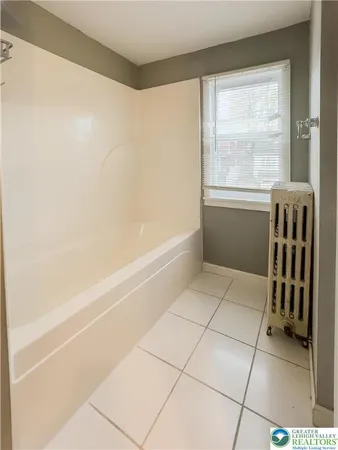 a bathroom with a granite countertop sink a toilet and mirror