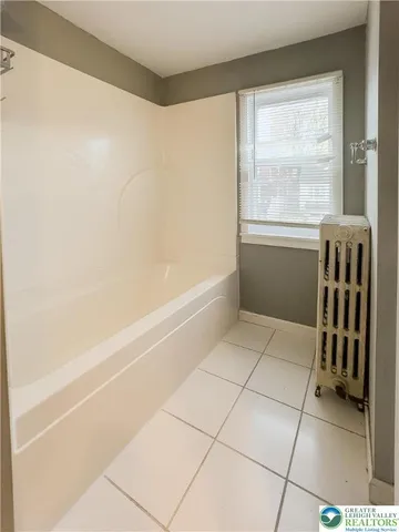 a bathroom with a granite countertop sink a toilet and mirror