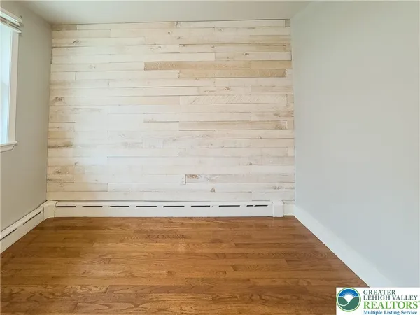 a view of a room with wooden floor