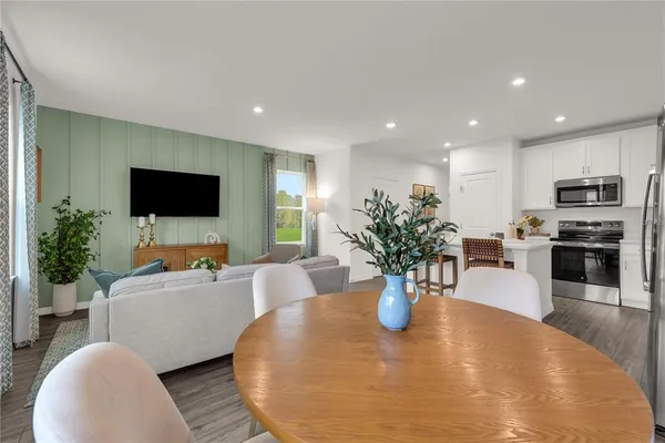 a view of a dining room with furniture and a potted plant