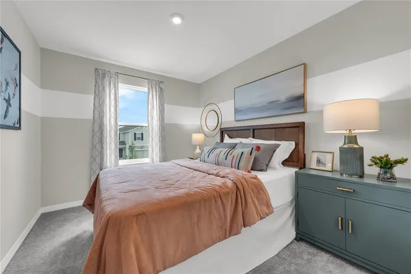 a bedroom with a bed and a lamp