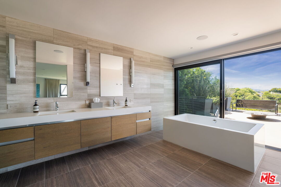 3337 Beverly Ranch Road Beverly Hills, CA 90210 - Photo 22 of 36 a large bathroom with a large tub and sink