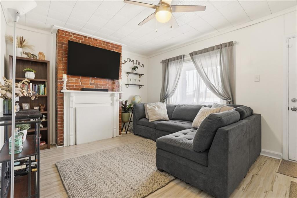 447 Edith Street Pittsburgh, PA 15211 - Photo 6 of 37 Living room with exposed brick and fireplace mantel