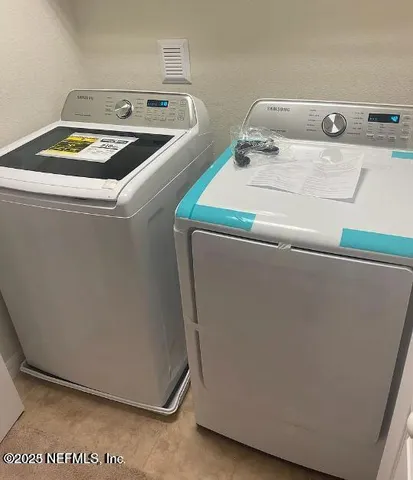 an empty room with wooden floor and ceiling fan