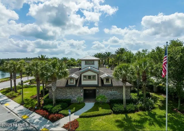 a front view of a house with a garden
