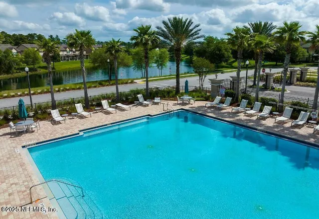 a view of an house with backyard space and balcony