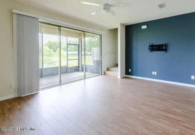 a view of a kitchen with a sink and a refrigerator