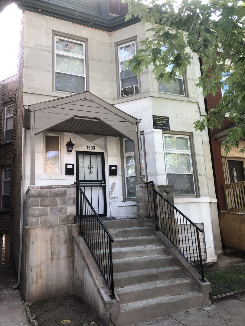 1903 South Hamlin Avenue Chicago, IL 60623 - Photo 1 of 2 a view of a brick house with large windows