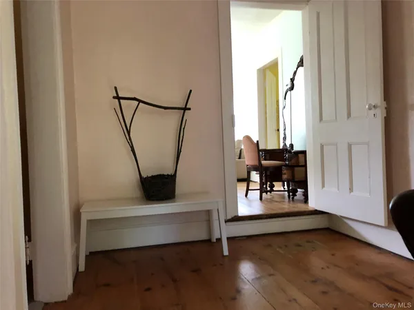 a view of entryway with wooden floor and stairs
