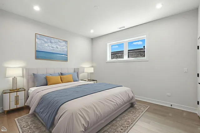 a bedroom with a large bed and a lamp