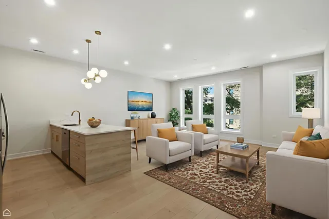 a living room with furniture a chandelier and a dining table